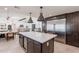 Modern kitchen with large island, stainless appliances, and eat-in dining area at 2724 W Colt Rd, Chandler, AZ 85224