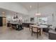 Open kitchen featuring a large island, modern appliances, and a dining area with comfortable seating at 2724 W Colt Rd, Chandler, AZ 85224