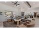 Bright living room featuring a large sectional sofa, neutral colors, and great natural light at 2724 W Colt Rd, Chandler, AZ 85224