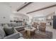 Bright open-concept living room with vaulted ceilings, wood beams, and view into a modern kitchen at 2724 W Colt Rd, Chandler, AZ 85224