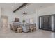 Bright and spacious living room featuring vaulted ceilings, exposed beams, and comfortable seating areas at 2724 W Colt Rd, Chandler, AZ 85224