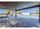 Covered patio with view of pool, rock waterfall, detached garage and well maintained landscaping at 2724 W Colt Rd, Chandler, AZ 85224