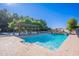 Stunning backyard pool area with rock waterfall, slide, pergola, and lush landscaping at 2724 W Colt Rd, Chandler, AZ 85224