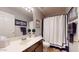 Bathroom featuring a vanity with a sink, toilet, and bathtub-shower combination with a stylish shower curtain at 2845 E Calavar Rd, Phoenix, AZ 85032