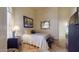 Comfortable bedroom features a well-lit space, a decorative mirror, and warm artistic piece at 2845 E Calavar Rd, Phoenix, AZ 85032