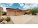 Spacious three car garage and expansive driveway with desert landscaping at 2845 E Calavar Rd, Phoenix, AZ 85032