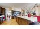 Open kitchen features dark wood cabinets, stainless steel appliances, and a large center island at 2845 E Calavar Rd, Phoenix, AZ 85032