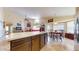 Open concept kitchen and living area feature an island, dining space, and a seamless flow at 2845 E Calavar Rd, Phoenix, AZ 85032