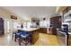 The kitchen features an island with seating, stainless steel appliances, and dark cabinets at 2845 E Calavar Rd, Phoenix, AZ 85032