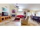 Spacious living room features a ceiling fan, fireplace, and ample natural light, perfect for relaxing at 2845 E Calavar Rd, Phoenix, AZ 85032