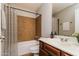 Well-lit bathroom features a shower-tub combo with neutral tones and a warm, wood vanity at 2922 S Cottonwood Dr, Tempe, AZ 85282