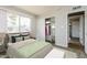 Bright bedroom showcasing a closet with white doors and a large window for ample natural light at 2922 S Cottonwood Dr, Tempe, AZ 85282