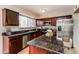 Modern kitchen with stainless steel appliances, dark wood cabinets and granite countertops at 2922 S Cottonwood Dr, Tempe, AZ 85282