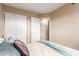Well-lit bedroom features floral bedding and convenient closet access at 2941 N Oregon St # 12, Chandler, AZ 85225