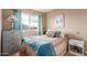 Cozy bedroom featuring a window with curtains, a dresser, and a bedside table at 2941 N Oregon St # 12, Chandler, AZ 85225