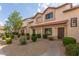 Charming townhouse with a well-maintained desert landscape and a red tile roof under a partly cloudy sky at 2941 N Oregon St # 12, Chandler, AZ 85225