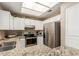 Bright kitchen featuring granite countertops, stainless steel appliances, and ample white cabinets at 2941 N Oregon St # 12, Chandler, AZ 85225