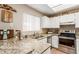 Bright kitchen featuring granite countertops, stainless steel appliances, and ample cabinet space at 2941 N Oregon St # 12, Chandler, AZ 85225