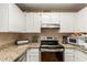 Well-lit kitchen featuring granite countertops, stainless steel appliances, and tiled flooring at 2941 N Oregon St # 12, Chandler, AZ 85225