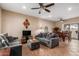 Comfortable living room with tile floors, neutral walls, ceiling fan, and a sliding glass door at 2941 N Oregon St # 12, Chandler, AZ 85225