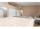 Large, carpeted main bedroom with a writing desk, walk in closet, and neutral color palate at 2941 N Oregon St # 12, Chandler, AZ 85225
