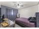 Bedroom with hardwood floors, ceiling fan, window, and mirror at 3307 W Willow Ave, Phoenix, AZ 85029
