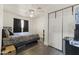 Simple bedroom with laminate flooring, a ceiling fan, and closet storage at 3307 W Willow Ave, Phoenix, AZ 85029