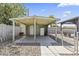 Carport with concrete floor, a white door, a white refrigerator, and string lights at 3307 W Willow Ave, Phoenix, AZ 85029