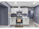 Well-equipped kitchen with white cabinets, quartz countertops, and stainless steel appliances at 3307 W Willow Ave, Phoenix, AZ 85029