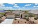 Aerial view of a single story home with a desert landscape, two car garage, and neutral color scheme at 3529 N Brooklyn Dr, Buckeye, AZ 85396