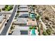 An aerial view shows neighborhood houses with pools and solar panels in a desert landscape at 3529 N Brooklyn Dr, Buckeye, AZ 85396