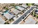 Aerial view showcases houses with private pools and solar panels on roofs within a desert landscape at 3529 N Brooklyn Dr, Buckeye, AZ 85396