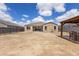 Wide angle shot of the backyard featuring a gazebo area and the home's exterior against a blue sky at 3529 N Brooklyn Dr, Buckeye, AZ 85396