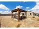 Spacious backyard with a covered outdoor dining area and a view of the home's exterior at 3529 N Brooklyn Dr, Buckeye, AZ 85396