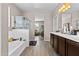 Full bathroom with double vanity sinks, a shower, and a tub, and wood-look flooring at 3529 N Brooklyn Dr, Buckeye, AZ 85396