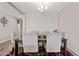 Bright dining room with elegant chandelier and seating for six at 3529 N Brooklyn Dr, Buckeye, AZ 85396