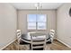 Inviting dining area with a round table, bright window, and durable laminate flooring at 3529 N Brooklyn Dr, Buckeye, AZ 85396