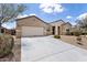 Charming single-story home with a two car garage, long driveway, and desert style landscaping at 3529 N Brooklyn Dr, Buckeye, AZ 85396