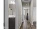 Hallway with wood-look flooring, neutral paint, leading to a bathroom and bedroom at 3529 N Brooklyn Dr, Buckeye, AZ 85396