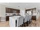 Stylish kitchen featuring an expansive island with seating, stainless steel appliances, and ample cabinet space at 3529 N Brooklyn Dr, Buckeye, AZ 85396