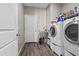 Laundry room equipped with a washer and dryer, utility sink, and access door to the outside at 3529 N Brooklyn Dr, Buckeye, AZ 85396