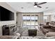 Comfortable living room featuring a ceiling fan and a sliding glass door for ample natural light at 3529 N Brooklyn Dr, Buckeye, AZ 85396