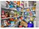 Organized pantry with shelves stocked full of a variety of food, drinks, and other household items at 3529 N Brooklyn Dr, Buckeye, AZ 85396