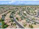 Expansive aerial view of a residential area highlighting numerous homes, streets, and scattered green spaces under a bright sky at 3905 S Bridal Vail Dr, Gilbert, AZ 85297