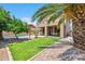 Beautiful backyard featuring a pool, palm trees and covered patio at 3905 S Bridal Vail Dr, Gilbert, AZ 85297