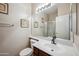 Bathroom featuring a large mirror, vanity with sink, toilet, and a glass-enclosed shower at 3905 S Bridal Vail Dr, Gilbert, AZ 85297