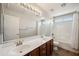 Bathroom features a double sink vanity, large mirror, and shower over tub combo at 3905 S Bridal Vail Dr, Gilbert, AZ 85297