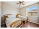 This bedroom features two beds, hardwood flooring, and a window providing natural light at 3905 S Bridal Vail Dr, Gilbert, AZ 85297