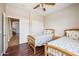 Cozy bedroom with two beds, hardwood flooring and access to additional areas of the home at 3905 S Bridal Vail Dr, Gilbert, AZ 85297