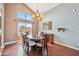 Formal dining room featuring a chandelier, hardwood floors, and large windows for ample light at 3905 S Bridal Vail Dr, Gilbert, AZ 85297
